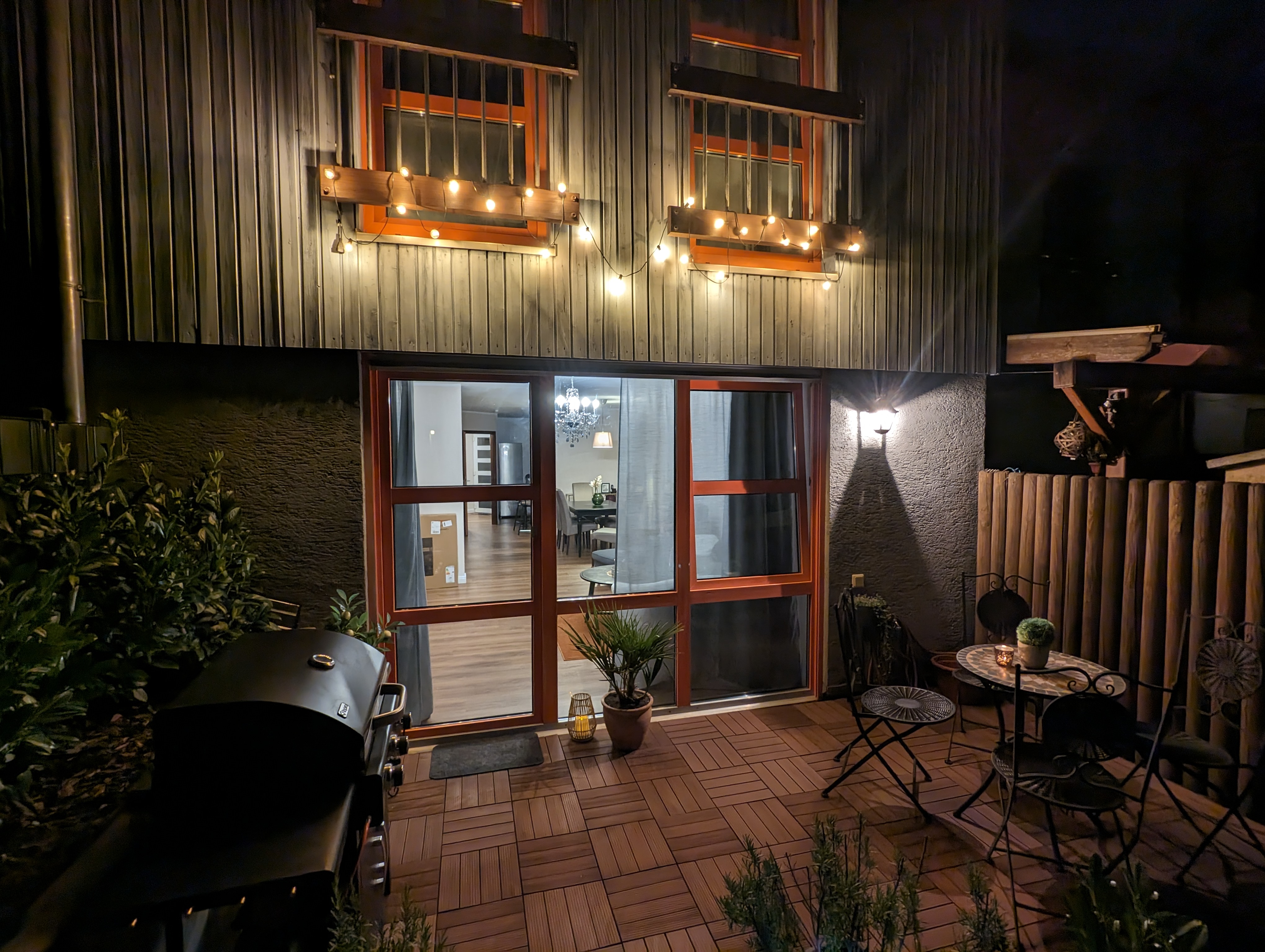 fenced backyard barbeque grill